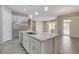 Open kitchen with granite counters, island, stainless appliances, and view to the living room at 7119 Falabella Ridge Ave, Las Vegas, NV 89131