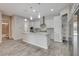 Open kitchen featuring white cabinets, granite countertops, and stainless steel appliances at 7119 Falabella Ridge Ave, Las Vegas, NV 89131