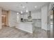 Open kitchen featuring white cabinets, granite countertops, and stainless steel appliances at 7119 Falabella Ridge Ave, Las Vegas, NV 89131
