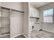 Well-organized laundry room with a sink, overhead cabinets, and open closet space at 7119 Falabella Ridge Ave, Las Vegas, NV 89131