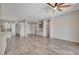 Open floor plan featuring a large living room with wet bar and wood-style tile flooring at 7119 Falabella Ridge Ave, Las Vegas, NV 89131
