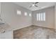 Living room featuring wood flooring, modern cabinets and window with blinds at 7119 Falabella Ridge Ave, Las Vegas, NV 89131