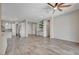 Open floor plan featuring a large living room with wet bar and wood-style tile flooring at 7119 Falabella Ridge Ave, Las Vegas, NV 89131