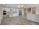 Open concept living space combining the kitchen, dining area, and a living room at 7119 Falabella Ridge Ave, Las Vegas, NV 89131