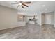 Spacious living room with wood tile floors opens to kitchen and dining area at 7119 Falabella Ridge Ave, Las Vegas, NV 89131