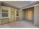 Covered outdoor patio with elegant brick pavers, a neutral color scheme, and a light filtering pergola at 7119 Falabella Ridge Ave, Las Vegas, NV 89131