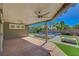 Covered patio overlooking a modern pool, spa, and firepit with a well-maintained and landscaped backyard at 7119 Falabella Ridge Ave, Las Vegas, NV 89131