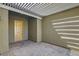 Private covered patio, featuring elegant pavers, neutral colors, and convenient access to an exterior door at 7119 Falabella Ridge Ave, Las Vegas, NV 89131