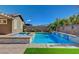 A backyard pool with a spa, water features, and lush landscaping at 7119 Falabella Ridge Ave, Las Vegas, NV 89131
