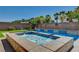 A backyard pool with a spa and decorative accents on the perimeter wall at 7119 Falabella Ridge Ave, Las Vegas, NV 89131