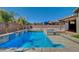 A backyard pool with a spa, baja step entry, and palm trees at 7119 Falabella Ridge Ave, Las Vegas, NV 89131