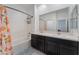 This well-lit bathroom offers a dual sink vanity and a shower-tub combination at 760 Crisp Morning Ct, North Las Vegas, NV 89086