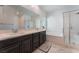 Bathroom with double vanity, a soaking tub and shower with glass door at 760 Crisp Morning Ct, North Las Vegas, NV 89086