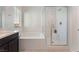 Clean bathroom with white subway tile shower, soaking tub and window with blinds at 760 Crisp Morning Ct, North Las Vegas, NV 89086