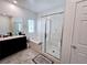 Bathroom featuring a soaking tub, enclosed shower, and modern fixtures at 760 Crisp Morning Ct, North Las Vegas, NV 89086