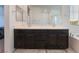 Bathroom with double vanity and soaking tub featuring dark cabinets and neutral walls at 760 Crisp Morning Ct, North Las Vegas, NV 89086