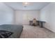 Bedroom featuring neutral carpet, a bed, and a desk with modern chair at 760 Crisp Morning Ct, North Las Vegas, NV 89086