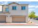 Attached garage with plenty of driveway parking, set against a blue sky backdrop at 760 Crisp Morning Ct, North Las Vegas, NV 89086
