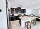 Stylish kitchen with dark cabinetry, a granite countertop island, and modern appliances, perfect for cooking and entertaining at 760 Crisp Morning Ct, North Las Vegas, NV 89086