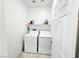 Convenient laundry room equipped with a washer, dryer, and storage shelving at 760 Crisp Morning Ct, North Las Vegas, NV 89086