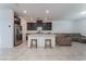 Open concept living area with tile floors, a modern kitchen and breakfast bar at 760 Crisp Morning Ct, North Las Vegas, NV 89086