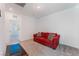 Comfortable living room featuring a red sofa and neutral carpet at 760 Crisp Morning Ct, North Las Vegas, NV 89086
