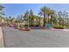 Community entrance to Rain Tree Villas with lush landscaping and desert plants at 7950 W Flamingo Rd # 1185, Las Vegas, NV 89147