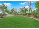 Well-manicured backyard featuring green grass, trees, and privacy walls at 8421 Vivid Violet Ave, Las Vegas, NV 89143