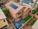 Aerial view of a backyard featuring a patio, faux grass, and privacy fence with some solar panels on the roof at 9316 Golden Lad Ave, Las Vegas, NV 89166