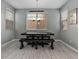 Dining room features rustic table with bench seating and a modern chandelier at 9316 Golden Lad Ave, Las Vegas, NV 89166