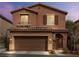 Inviting two-story home with brown stucco, tile roof and a spacious two-car garage at 9316 Golden Lad Ave, Las Vegas, NV 89166