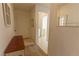 Inviting entryway with neutral walls, bench, and carpet, leading into the home at 9935 Swimming Hole St, Las Vegas, NV 89183