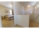Bright hallway leading to a comfortable bedroom with large window and neutral decor at 9935 Swimming Hole St, Las Vegas, NV 89183