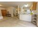 Open concept living room and kitchen offers great living space with neutral carpet at 9935 Swimming Hole St, Las Vegas, NV 89183