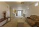 Open concept living room to kitchen with neutral carpet and access to patio at 9935 Swimming Hole St, Las Vegas, NV 89183