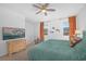 Bright bedroom with plush carpet, neutral decor, ceiling fan, and two windows at 10009 Locking Biner Ave, Las Vegas, NV 89166