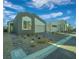 Contemporary home featuring neutral stucco, a two-car garage, and low maintenance desert landscaping at 10009 Locking Biner Ave, Las Vegas, NV 89166