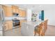 Modern kitchen with granite countertops, stainless steel appliances, a kitchen island, and tile floors at 10009 Locking Biner Ave, Las Vegas, NV 89166