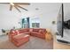 Inviting living room featuring a comfortable sectional sofa, ceiling fan, and ample natural light at 10009 Locking Biner Ave, Las Vegas, NV 89166
