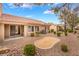 Well-maintained backyard with desert landscaping, a sand pit, and patio at 10041 Arbuckle Dr, Las Vegas, NV 89134