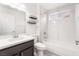 Bathroom boasts a shower-over-tub, a dual-shelved corner unit, and a sink with dark wooden cabinetry at 10041 Arbuckle Dr, Las Vegas, NV 89134