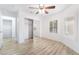Bedroom showcases wood-look floors, closet with mirrored door, ceiling fan, and shuttered windows at 10041 Arbuckle Dr, Las Vegas, NV 89134