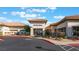 Exterior view of Sun City Aliante clubhouse featuring covered entrance, desert landscaping and ample parking at 10041 Arbuckle Dr, Las Vegas, NV 89134