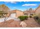 Charming single-story home with a well-maintained desert landscape and a two-car garage at 10041 Arbuckle Dr, Las Vegas, NV 89134