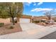 Single-story home with a two car garage featuring desert landscaping, gravel ground cover and driveway at 10041 Arbuckle Dr, Las Vegas, NV 89134
