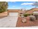 Single-story home with a two car garage featuring desert landscaping, gravel ground cover and driveway at 10041 Arbuckle Dr, Las Vegas, NV 89134