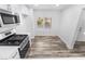 Eat-in kitchen featuring stainless steel appliances, window views, and modern floors at 10041 Arbuckle Dr, Las Vegas, NV 89134