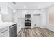 Bright kitchen features stainless steel appliances, white cabinets, and durable wood flooring at 10041 Arbuckle Dr, Las Vegas, NV 89134