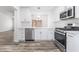 Bright kitchen features stainless steel appliances, white cabinets, and wood-look floors at 10041 Arbuckle Dr, Las Vegas, NV 89134