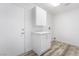 Functional laundry room featuring bright white cabinets and countertops with wood-look flooring at 10041 Arbuckle Dr, Las Vegas, NV 89134